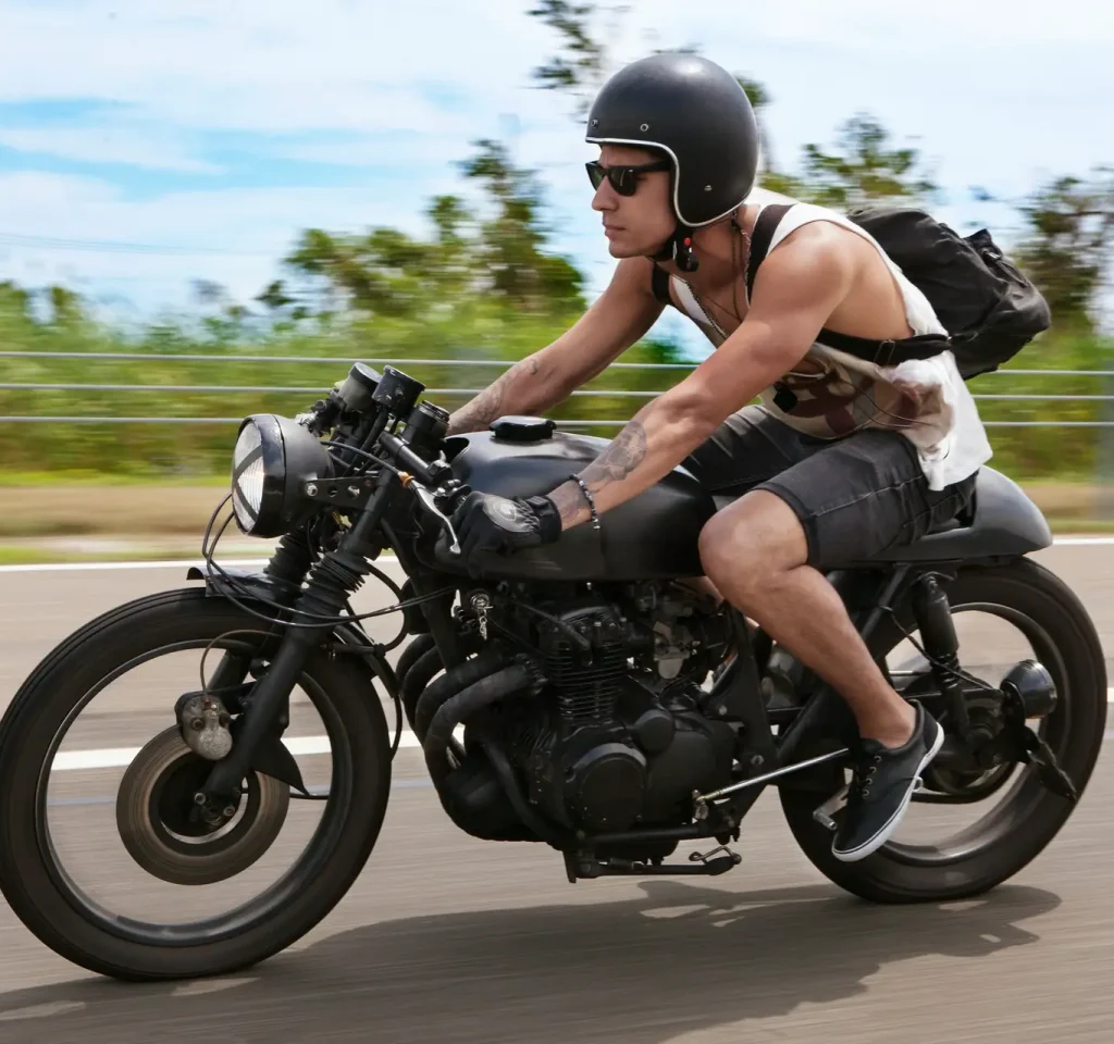 man-with-backpack-riding-motorcycle-on-road.jpg